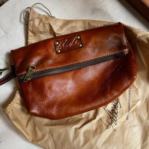 Patricia Nash solid leather fold over clutch.